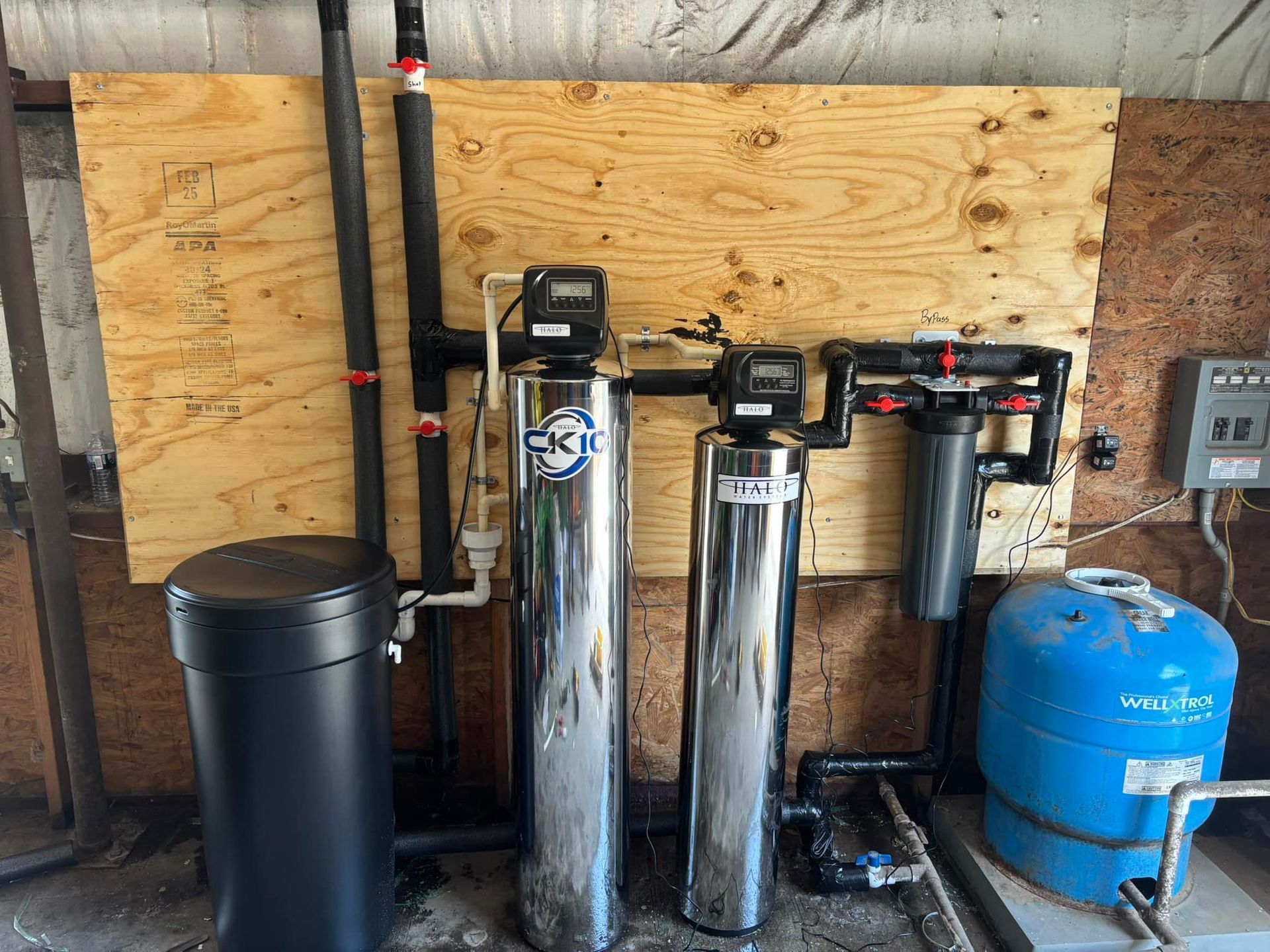 Two stainless steel water filters are sitting next to each other in a room.
