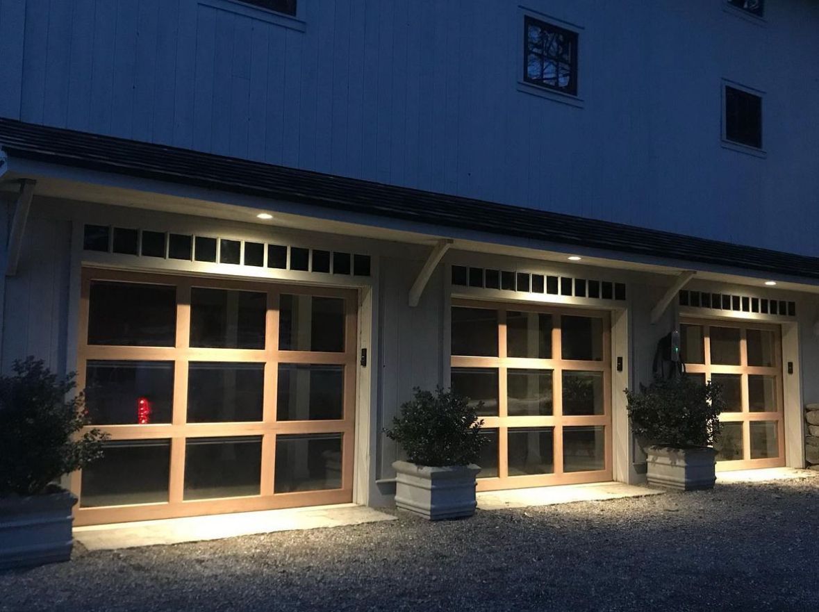 a row of garage doors are lit up at night