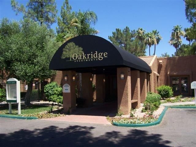 A building with a black awning that says oakridge