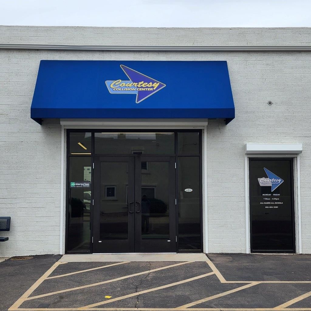 A white building with a blue awning that says Zimmerman on it