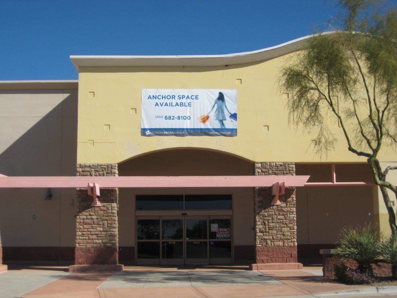 A yellow building with a sign on it that says anchor well available