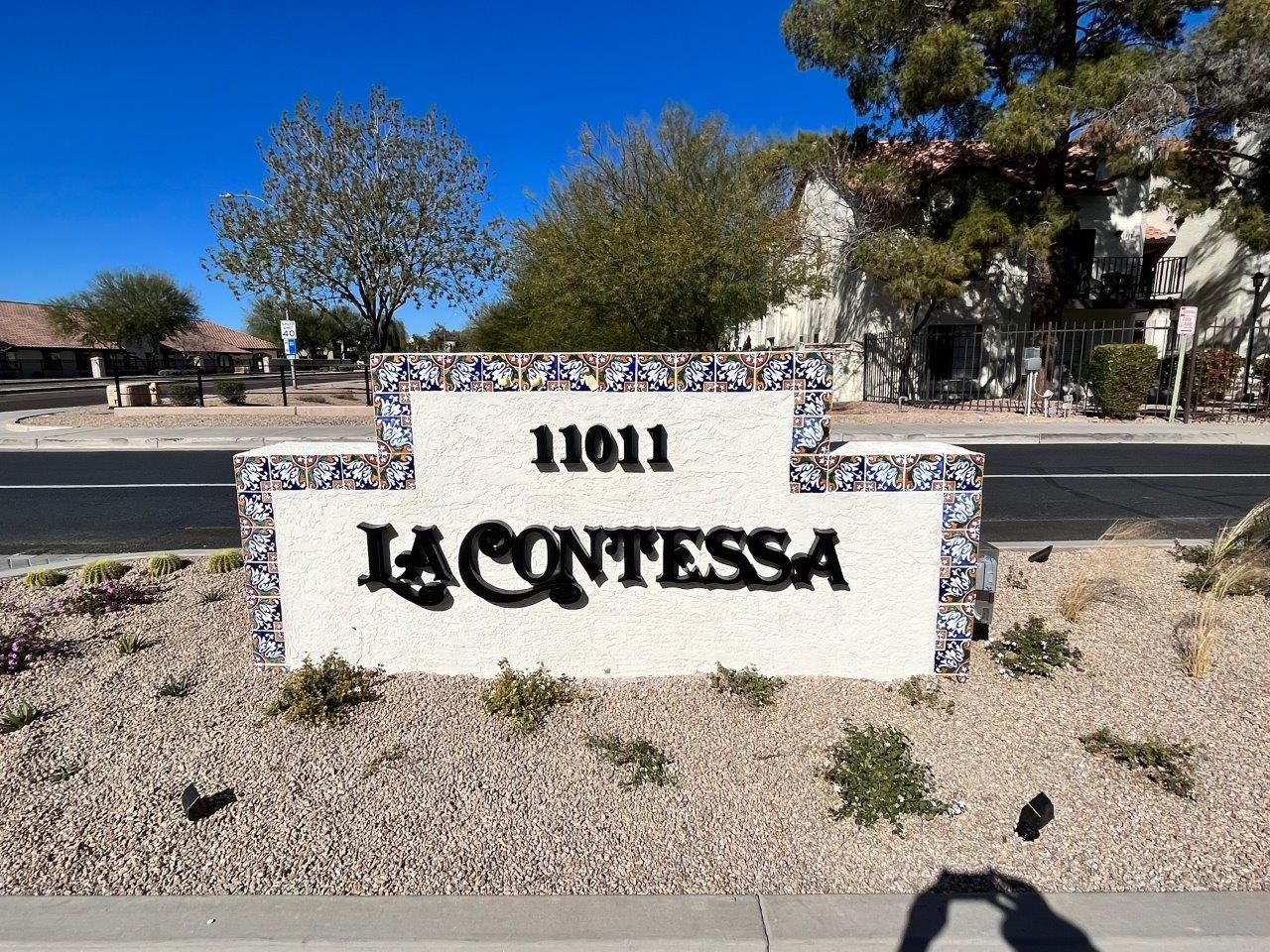 A sign for la contessa sits on the side of the road