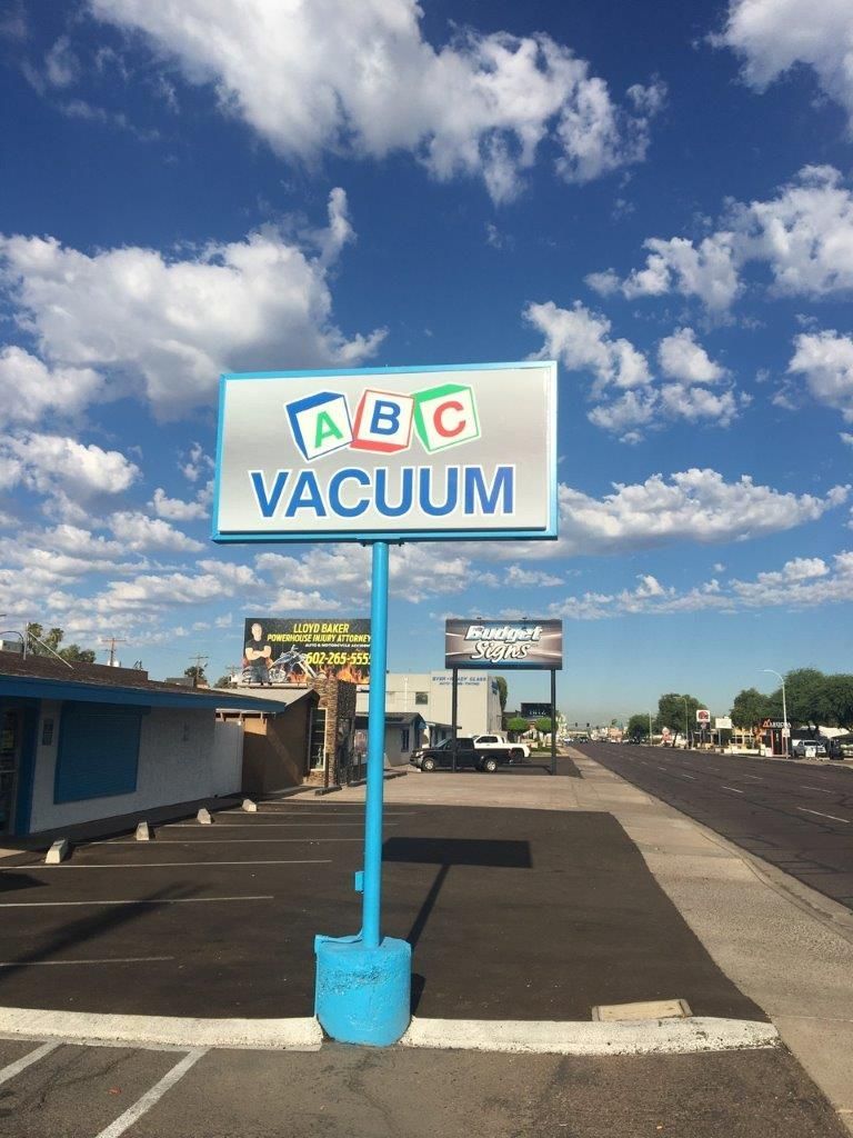 A sign that says abc vacuum in a parking lot