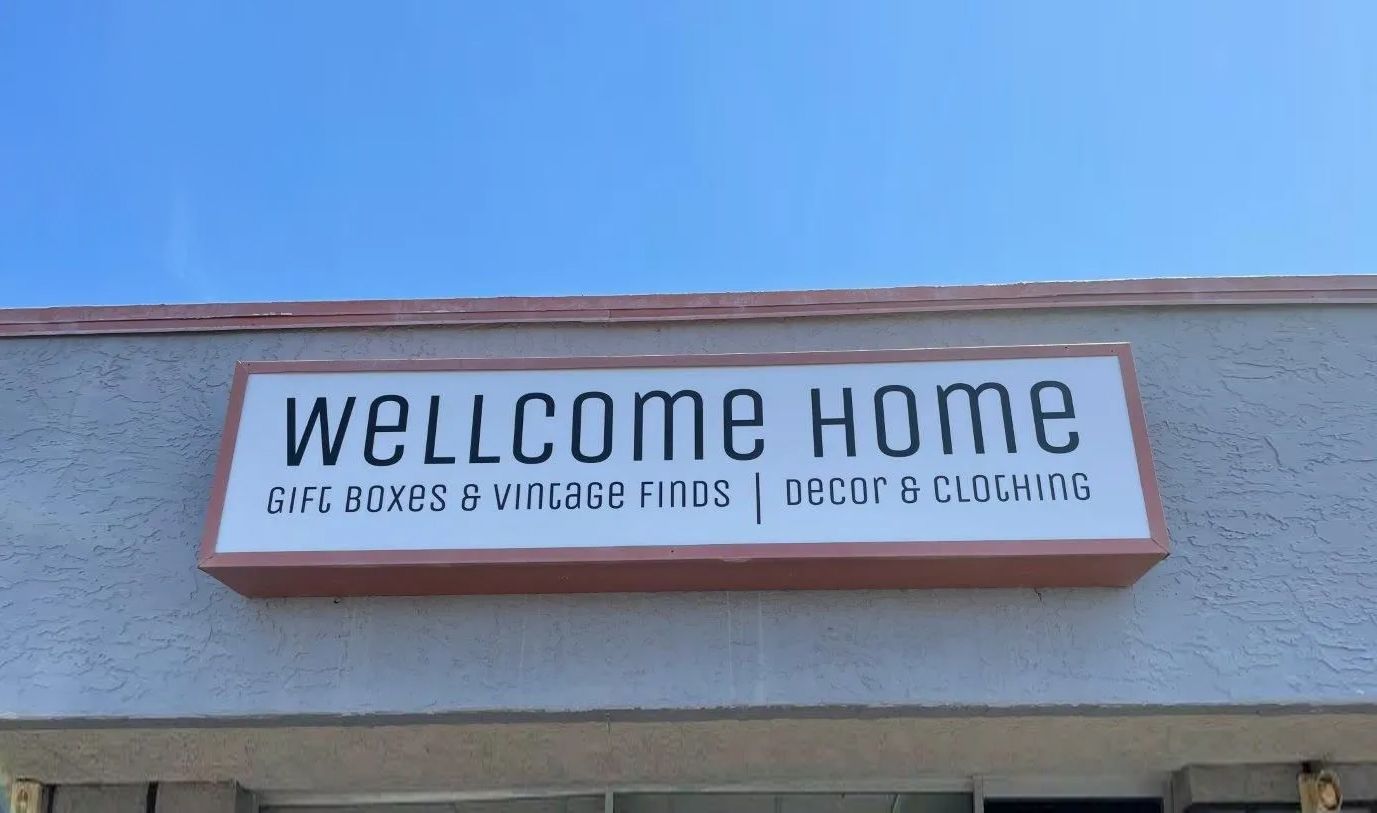 A sign on the side of a building that says wellcome home