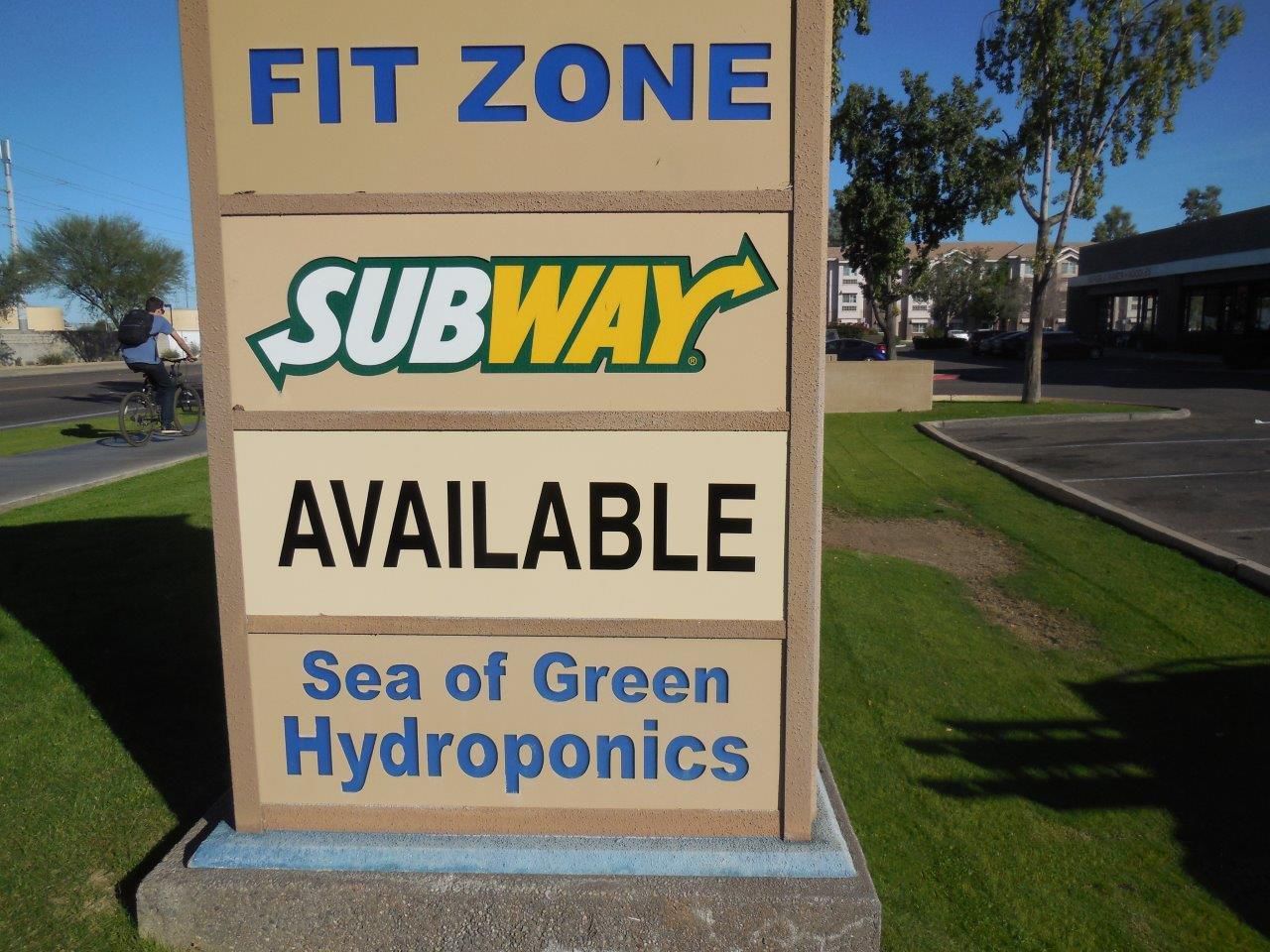 A sign for fit zone subway and sea of green hydroponics