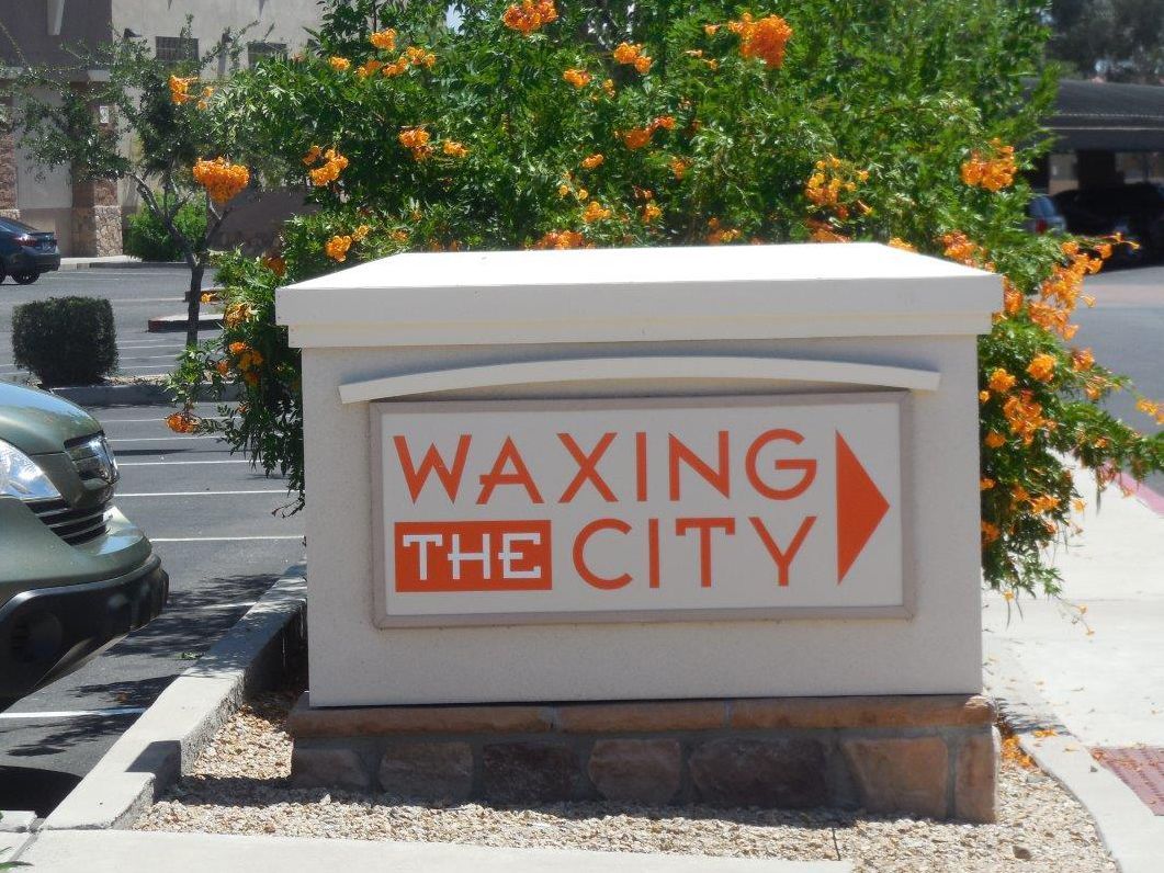A sign that says waxing the city on it