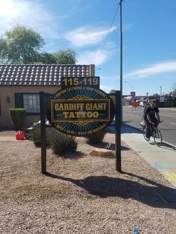 A sign that says cardiff giant tattoo on it
