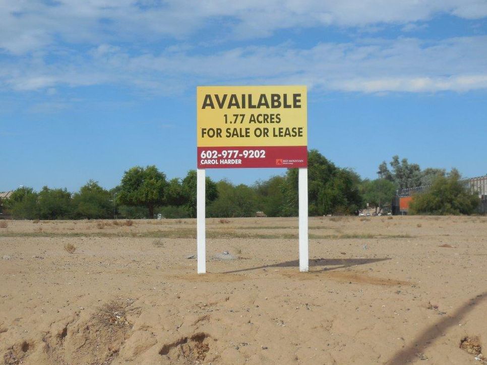A yellow sign that says available 1.77 acres for sale or lease