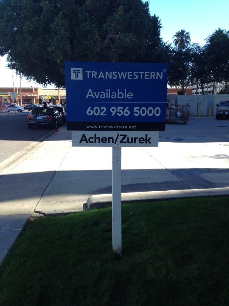 A blue sign that says transwestern available on it
