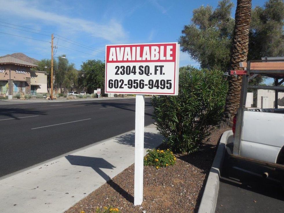 A sign on the side of the road that says available