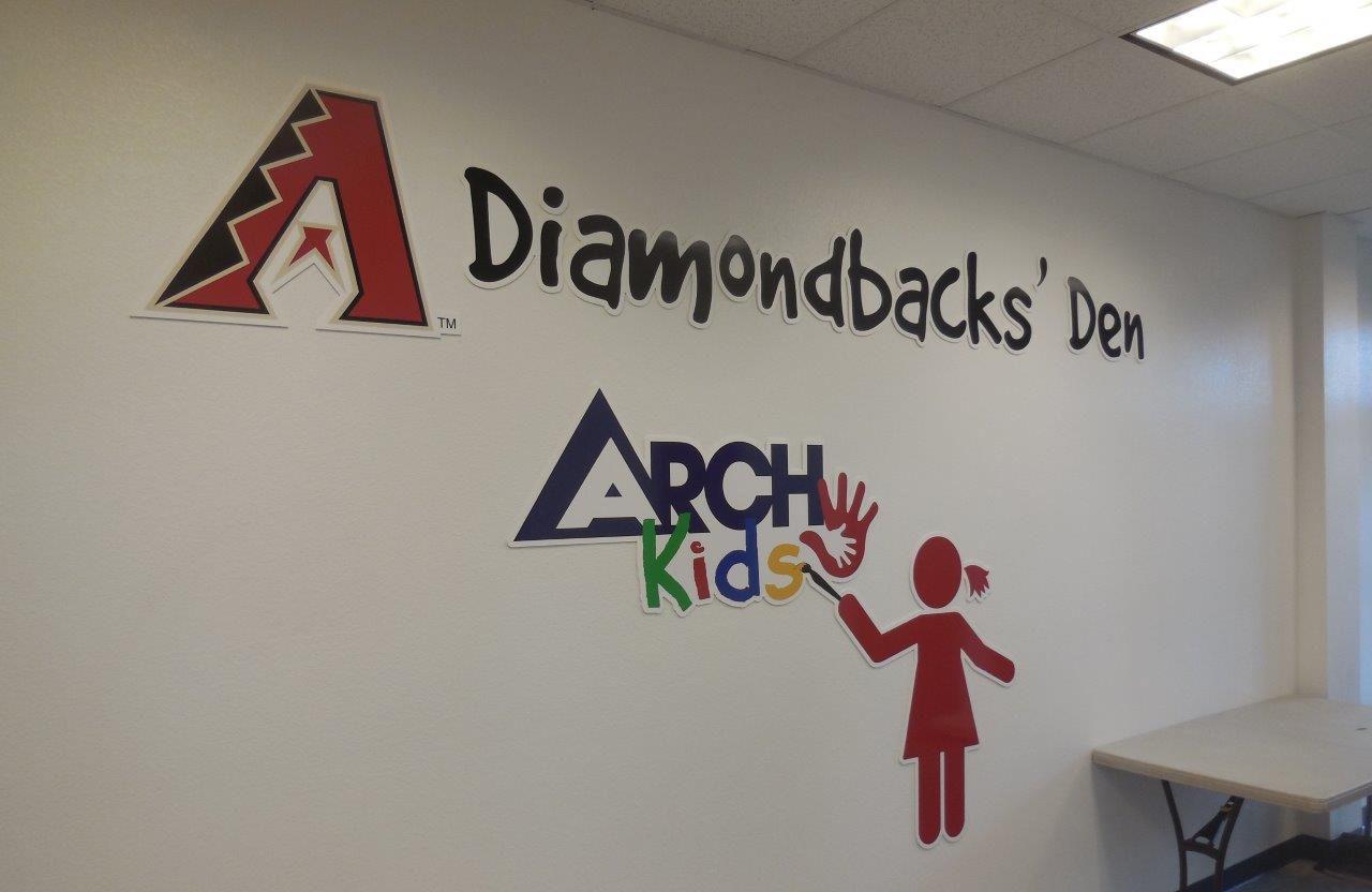 A wall with the words diamondbacks den and arch kids painted on it