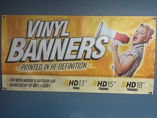 a vinyl banner with a woman holding a megaphone