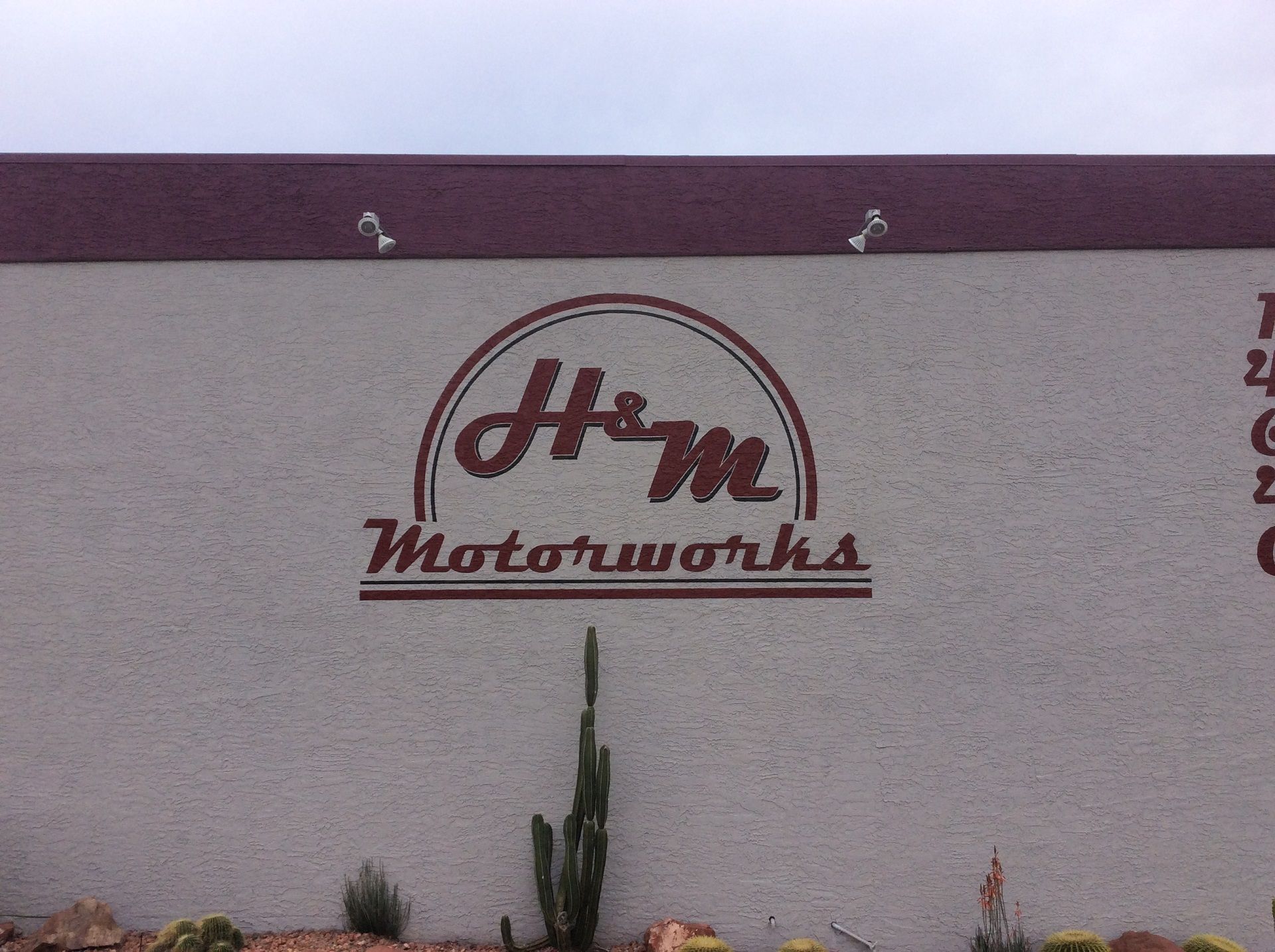A sign on the side of a building that says home motorworks