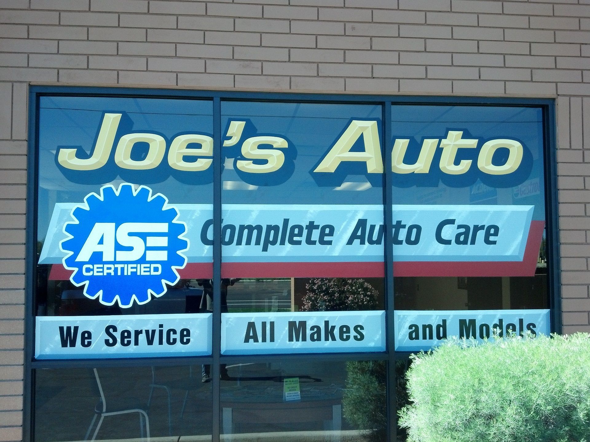 hand-painted sign advertising Joe's Auto