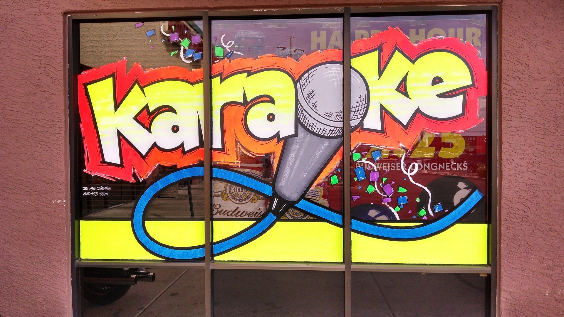 A window with a karaoke sign on it