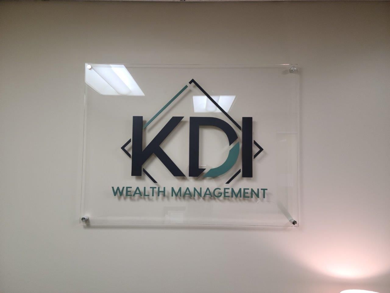 A sign that says kdi wealth management on it