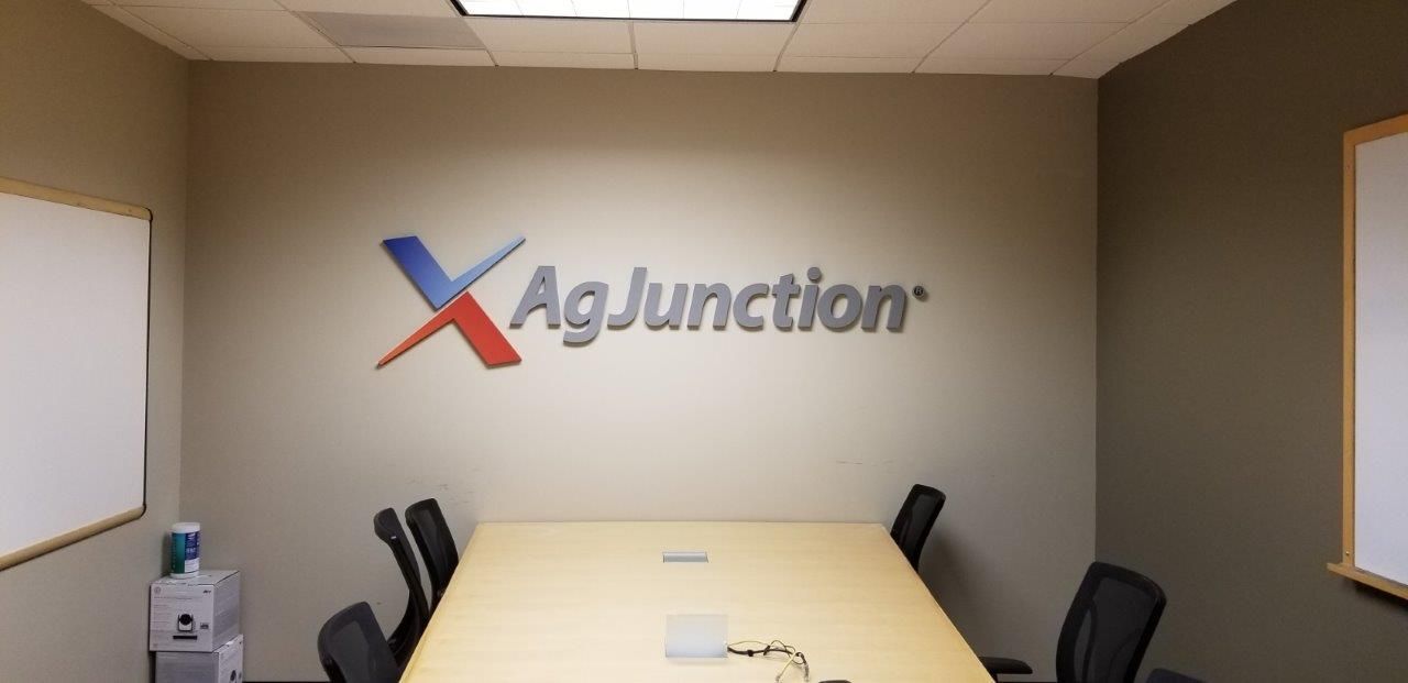 A conference room with a sign on the wall that says agjunction