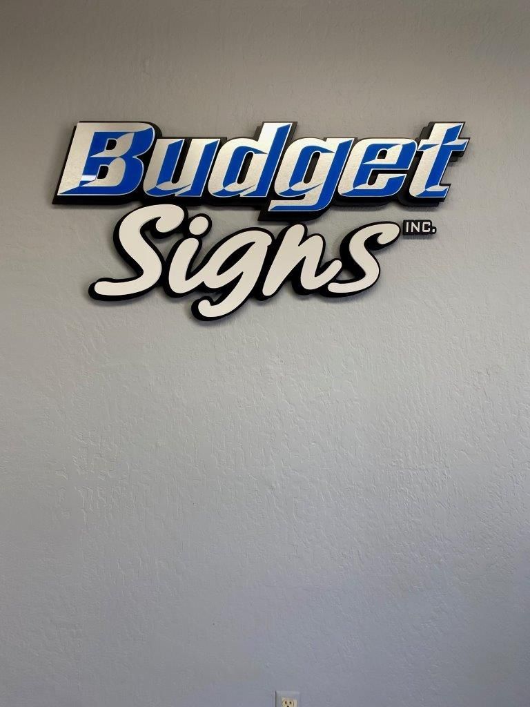 A sign on a wall that says budget signs