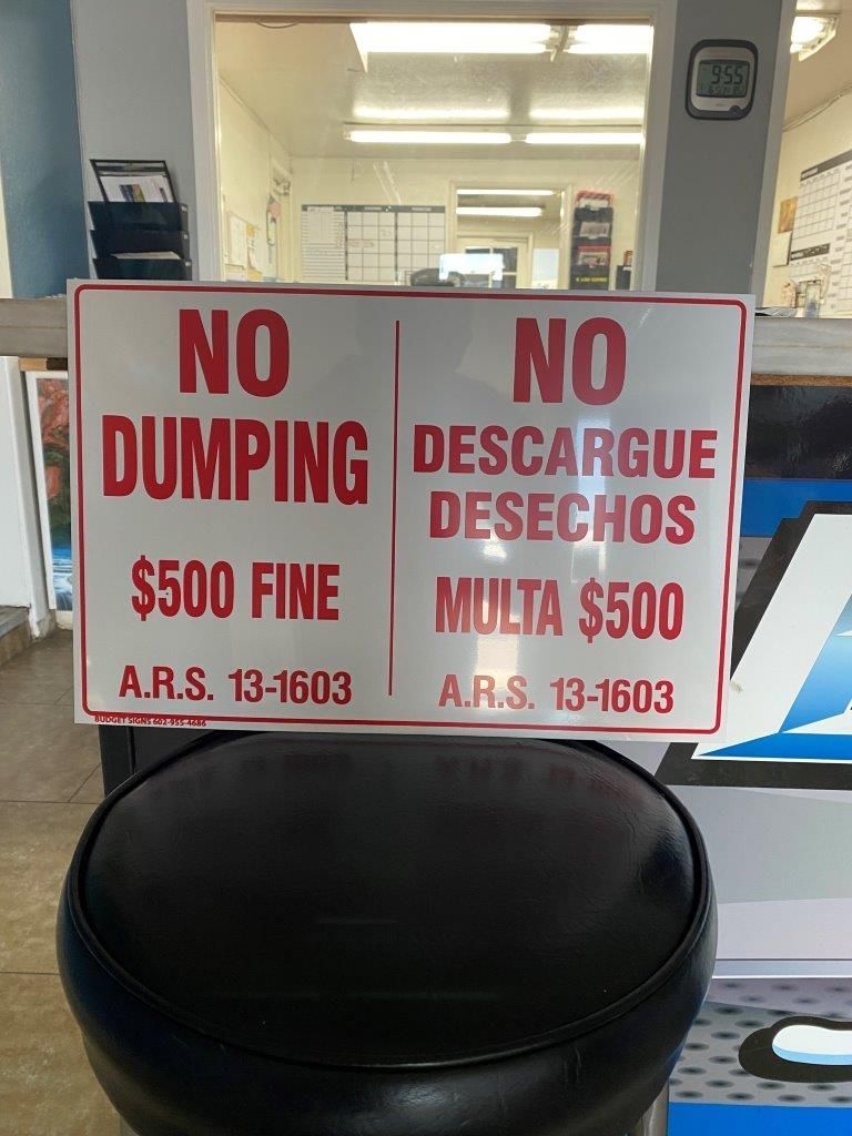 A sign that says no dumping on it