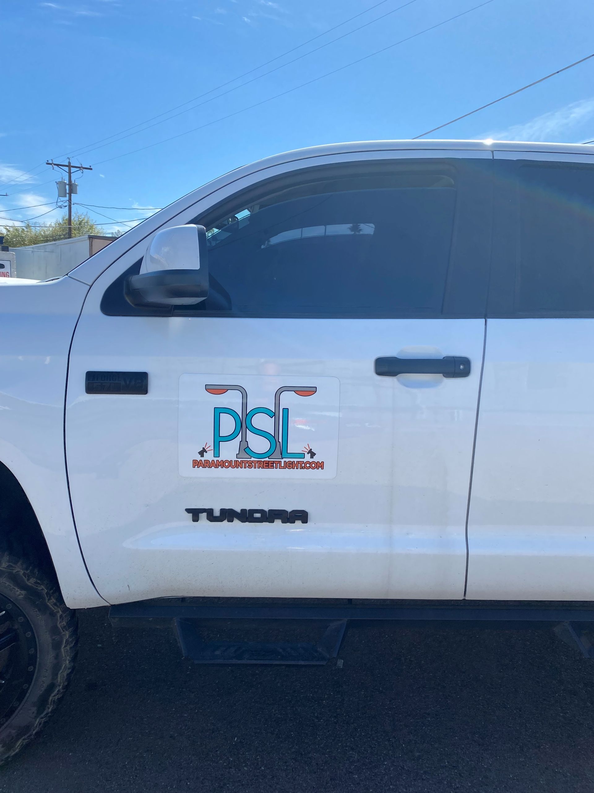 A white truck with a sticker on the side that says psi