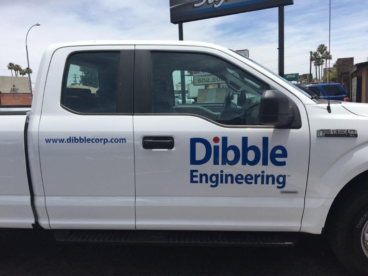 A white truck with dibble engineering written on the side