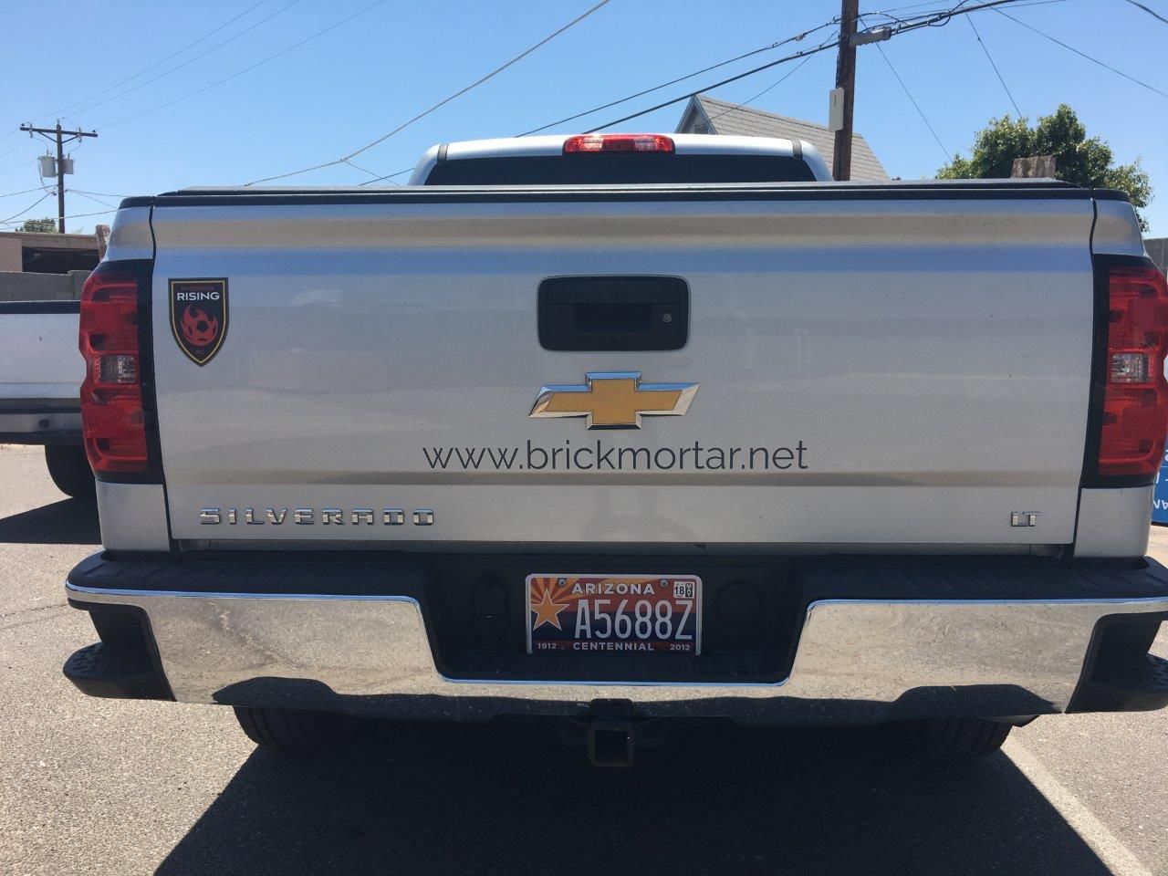 A silver truck with a license plate that says a568bz