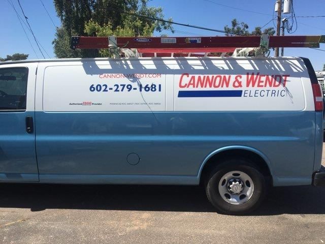 A cannon & wende electric van is parked on the side of the road
