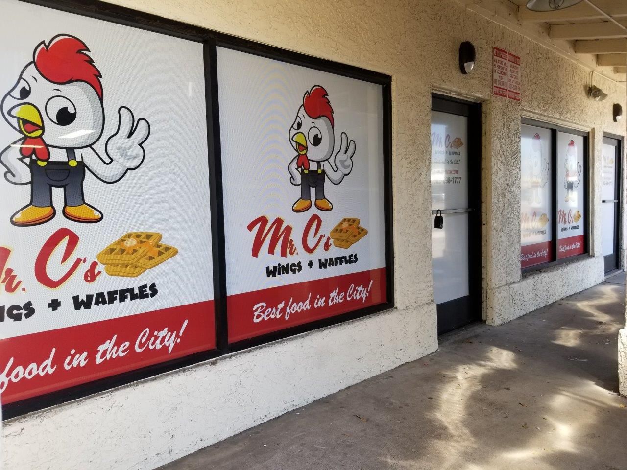 A store front with a sign that says mr. chicken wings waffles