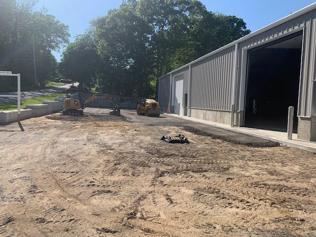 A large building with a lot of dirt in front of it.