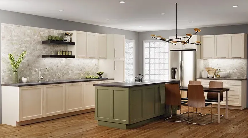 Kitchen with cream cabinets, sage green island, wood floor, and stainless steel refrigerator.