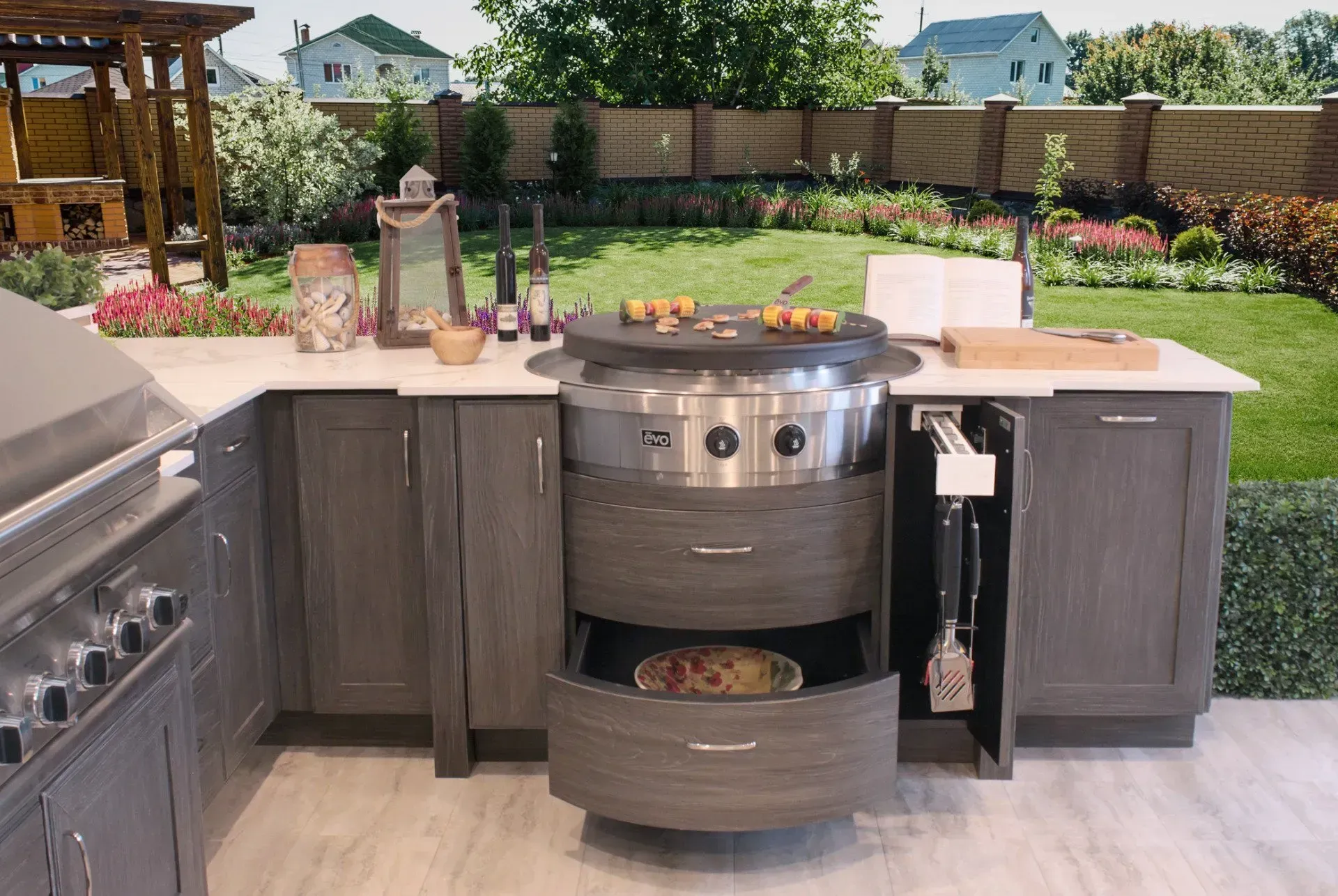 Outdoor kitchen with a grilling station and storage, set in a backyard.