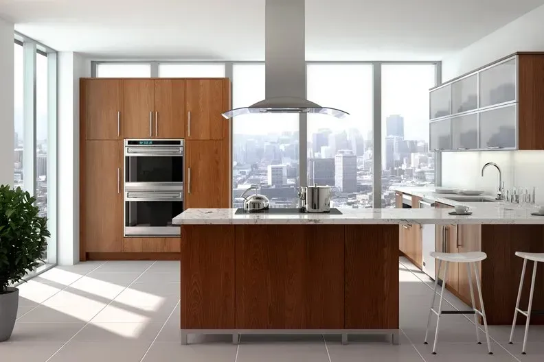 Modern kitchen with wooden cabinets, island, and large windows overlooking a city skyline.