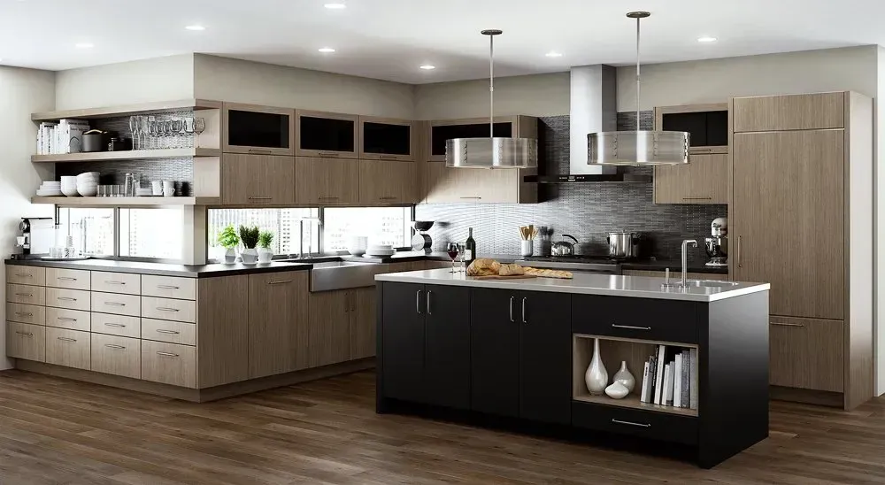 Modern kitchen with light wood cabinets, black island, stainless steel appliances, and hardwood floors.