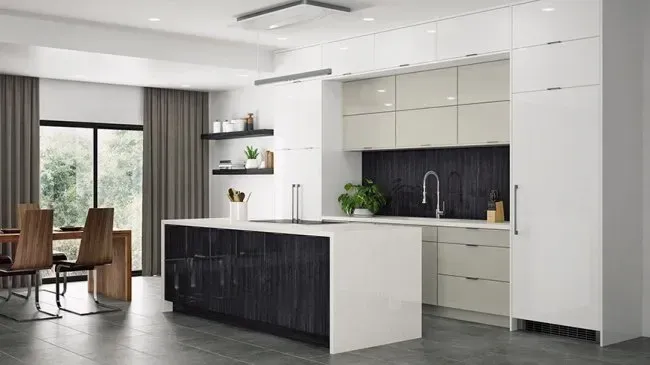 Modern kitchen with white and black cabinets, island, and sink; a dining table and windows are visible.