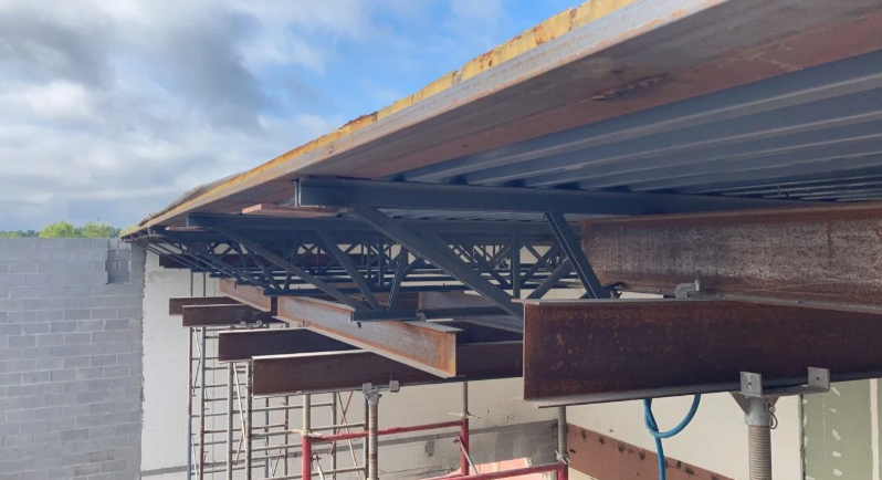 Close-up of a corrugated metal roof over an outdoor structure under construction