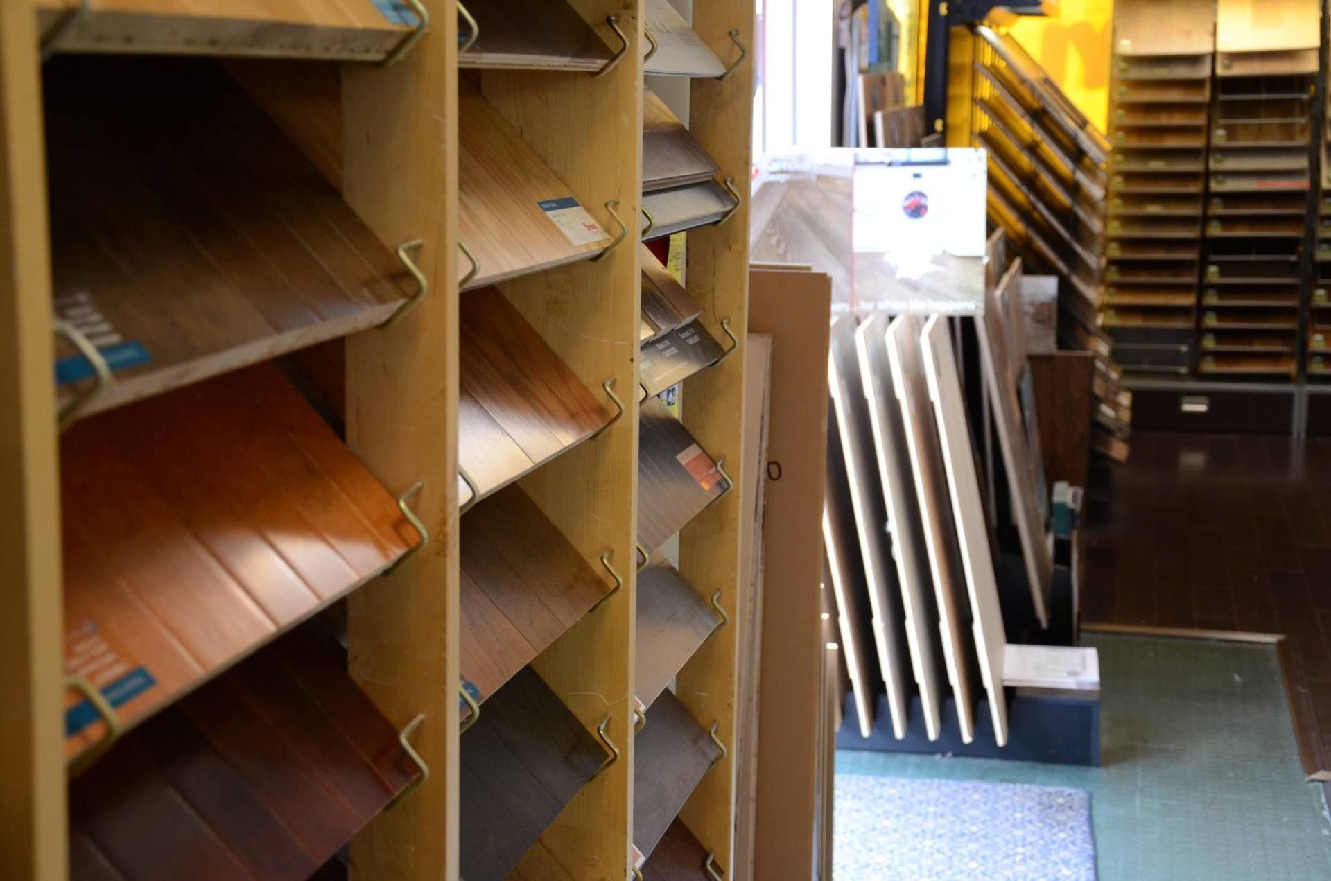 Shelves displaying samples of flooring in a store.