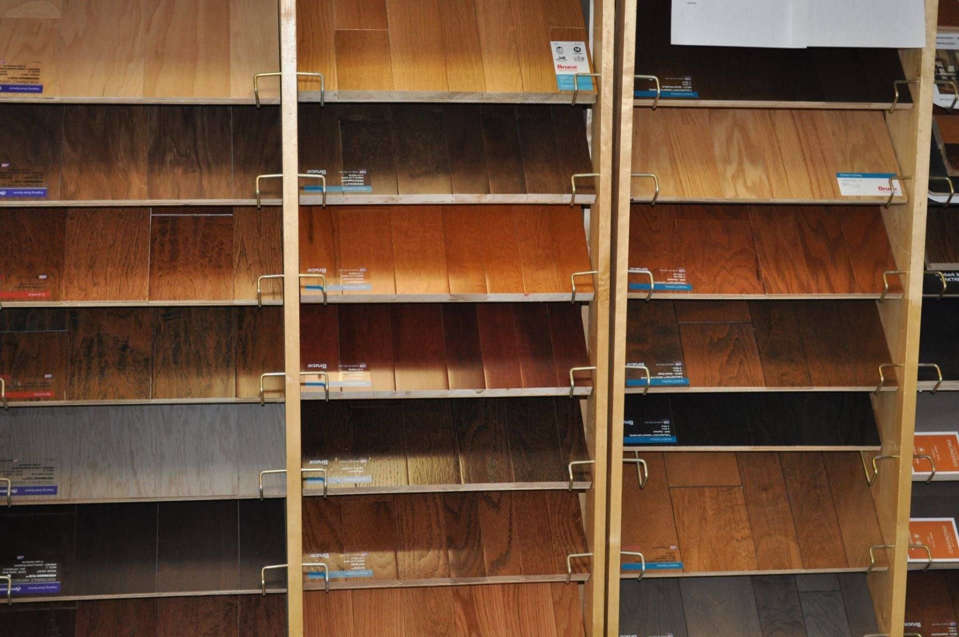 Samples of wood flooring displayed on shelves.