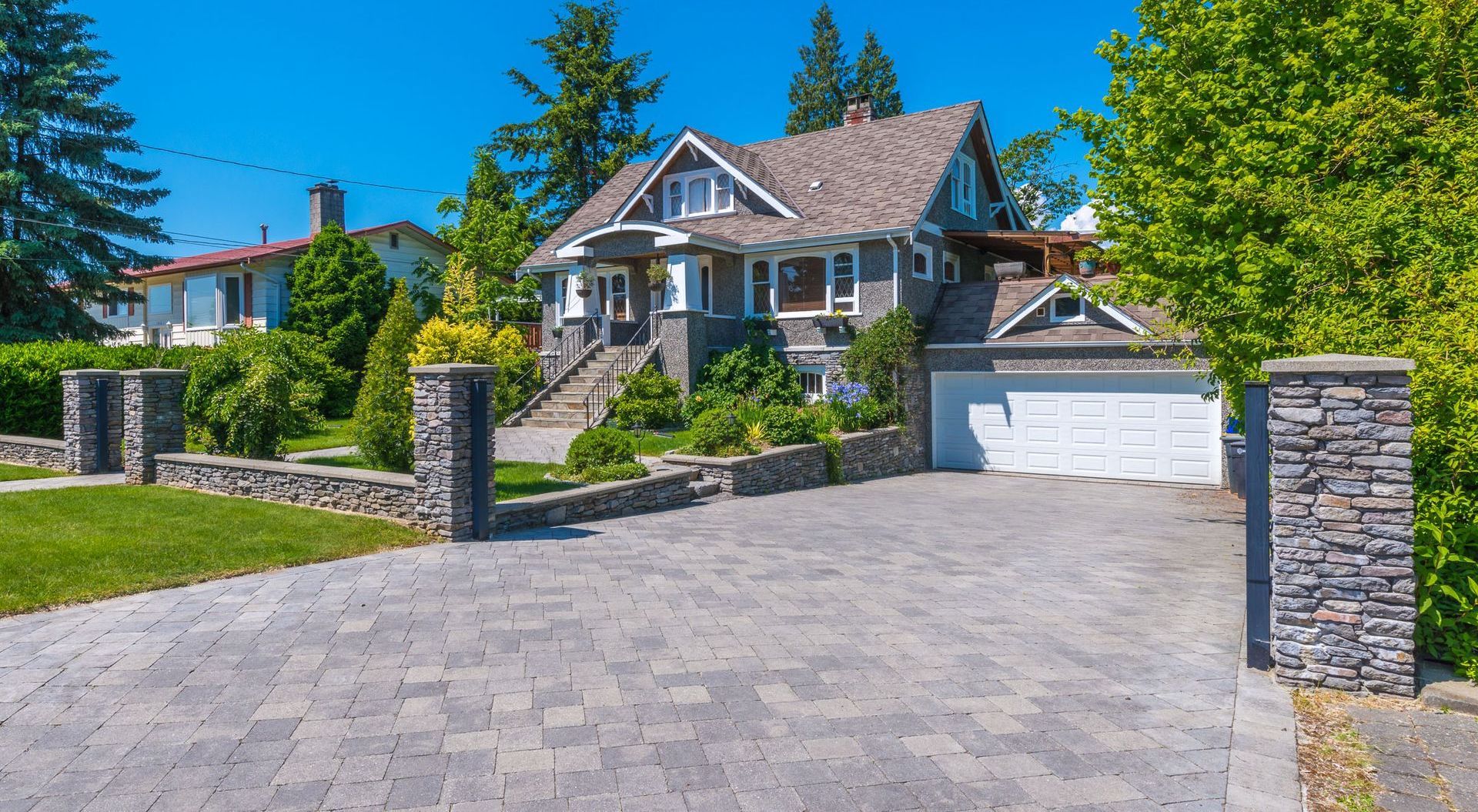 Beautifully designed pavers walkway leading through a lush garden