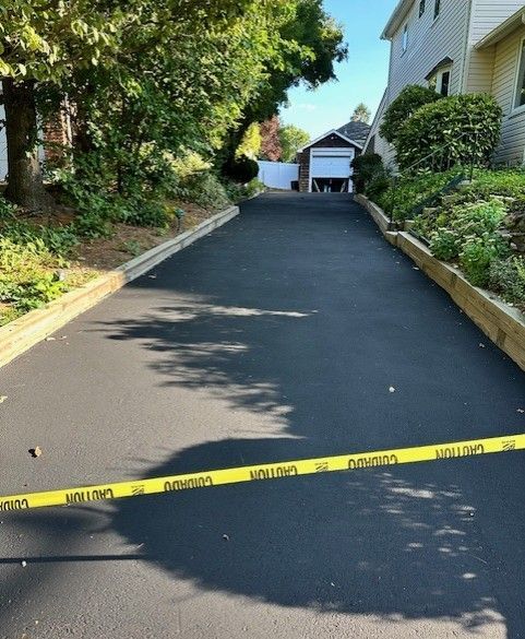A driveway with a yellow caution tape on it