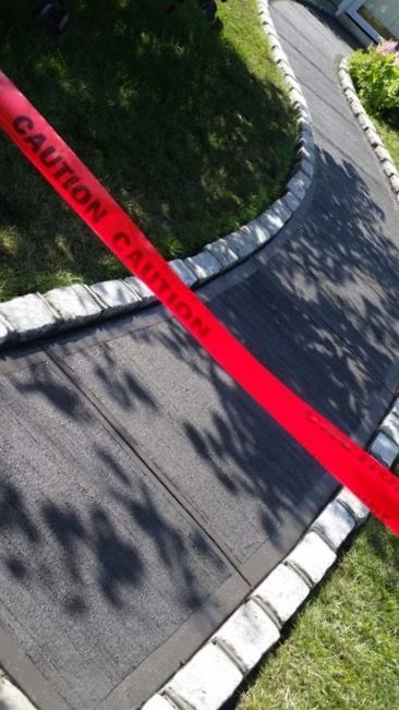 A red caution tape is on the sidewalk
