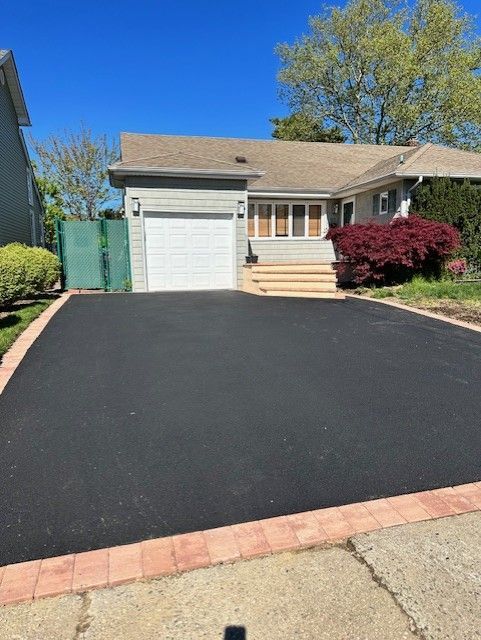 A driveway leading to a house with a white garage door