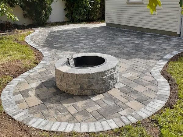 A well-crafted paver walkway surrounded by vibrant landscaping in a backyard.