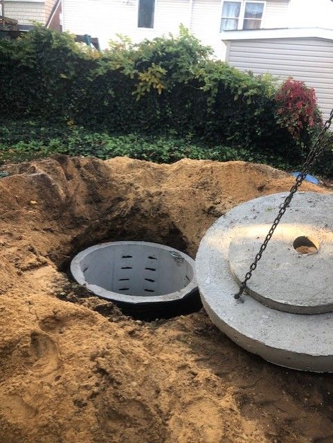 A septic tank is being installed in a hole in the ground.