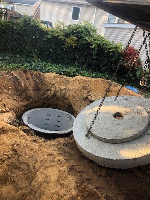 A septic tank is being installed in a backyard.