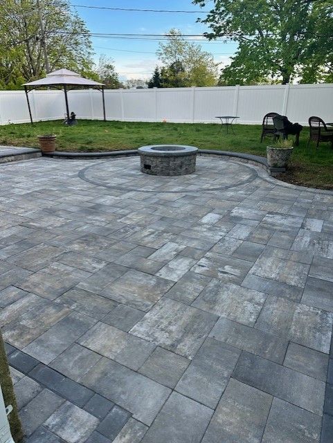 There is a fire pit in the middle of the patio.