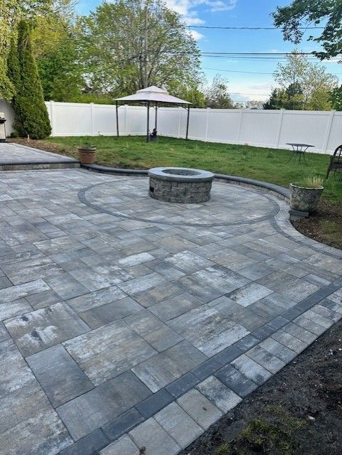 There is a fire pit in the middle of the patio.