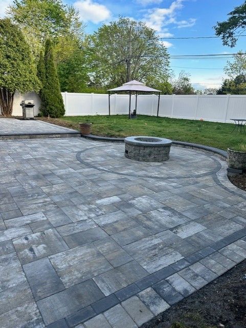 There is a fire pit in the middle of the patio.