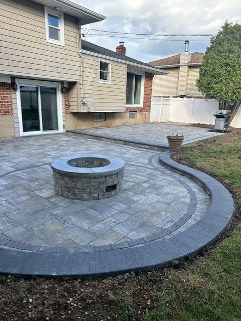 There is a fire pit in the middle of the patio.