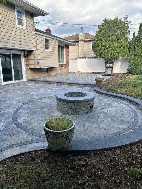 There is a fire pit in the middle of the patio.