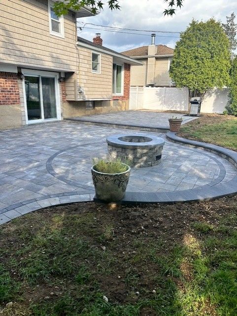 There is a fire pit in the middle of the patio.